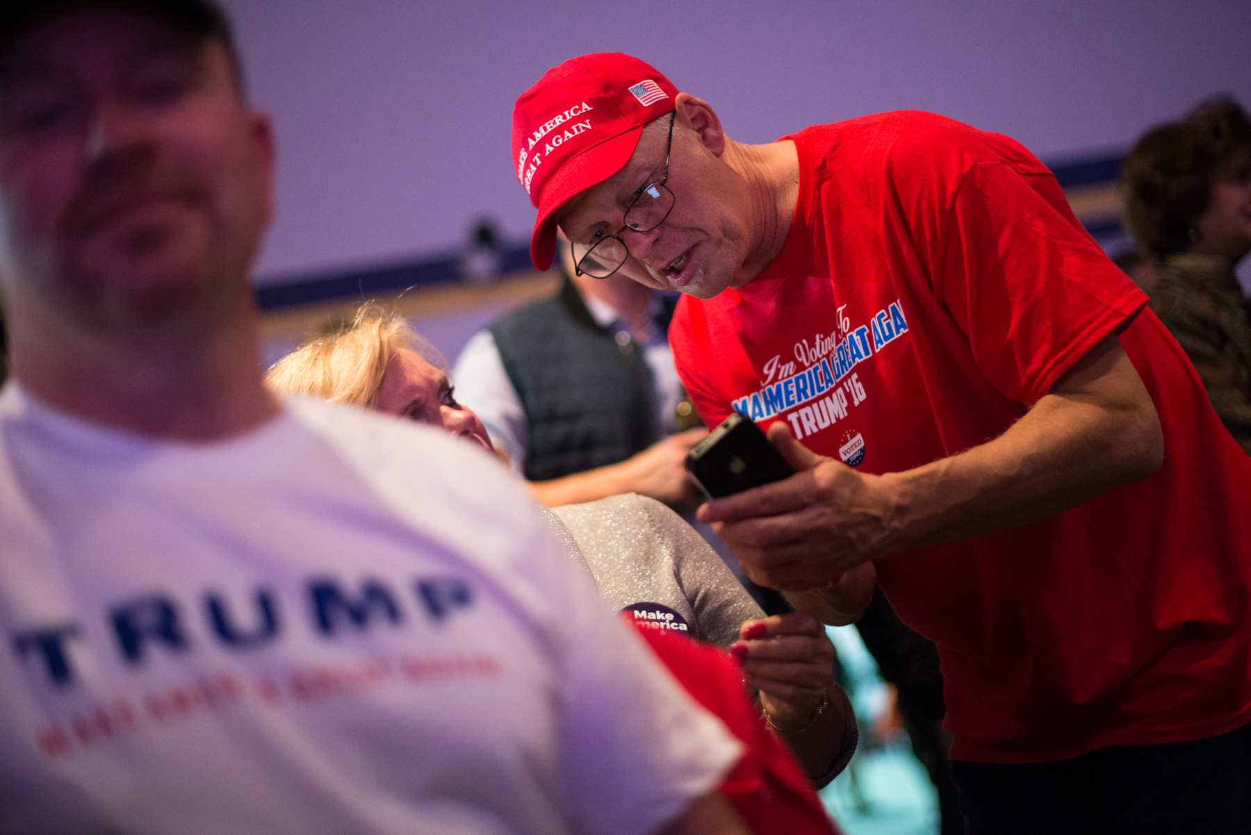 Braintree, MA – Nov. 8, 2016 – Ray Bourbeau, of Chicopee, Massachusetts, reads the latest victory prediction for United States presidential candidate Donald Trump on his phone during the Massachusetts Trump-Pence Campaign victory party. Trump supporters gathered at the F1 Boston race track to cheer on their nominee as he was elected 45th president of the United States.